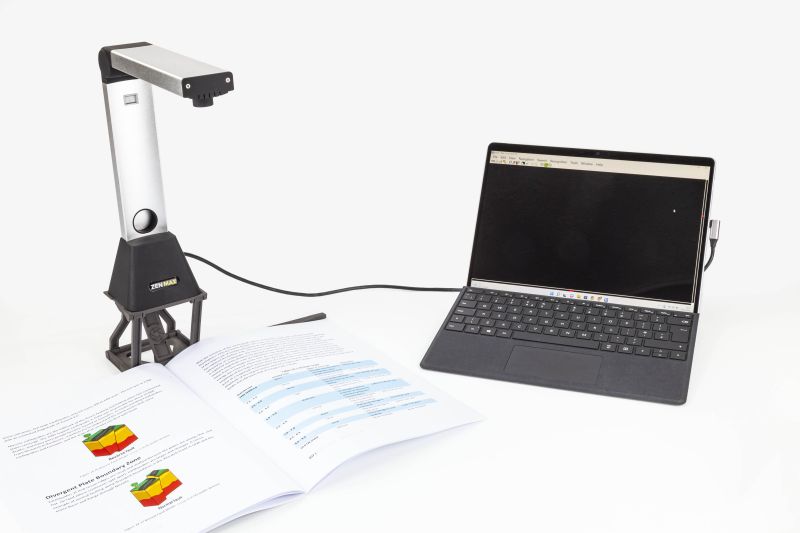 ZEN MAX attached to a laptop capturing a large textbook_web