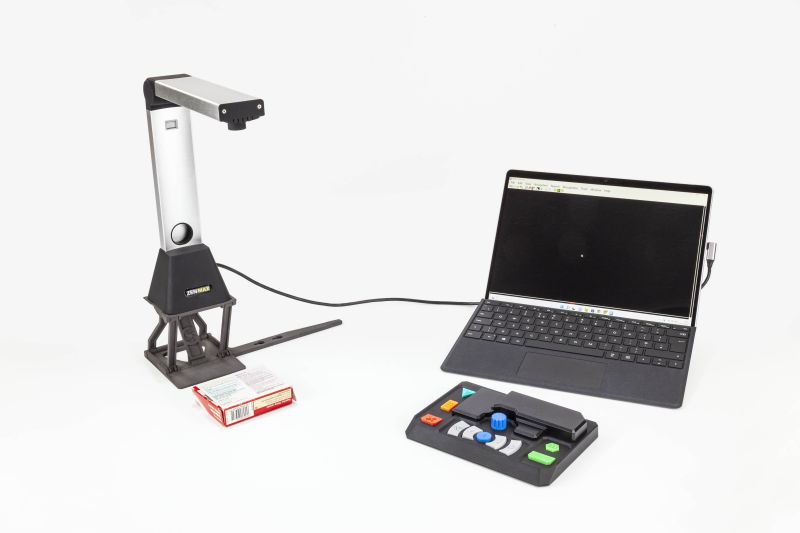 ZEN MAX attached to a laptop capturing a medicine package with keypad and simplifier in front of the